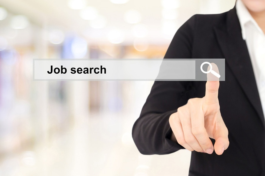 Businesswoman hand touching job search on search bar over blur background.jpg
